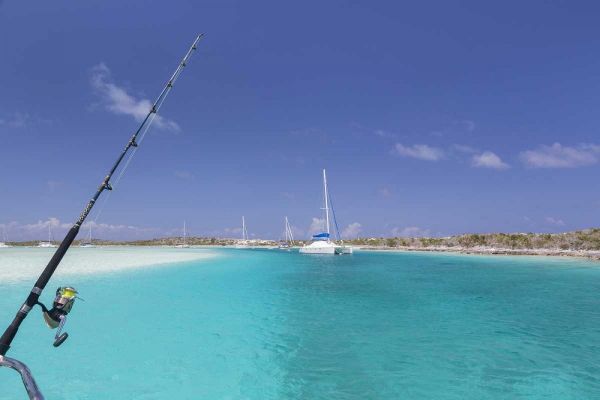 Bahamas, Exuma Island Sailboats and fishing rod